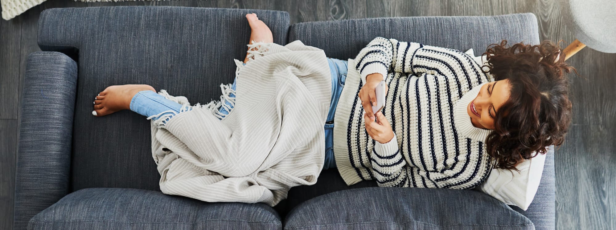 Woman on her phone on couch