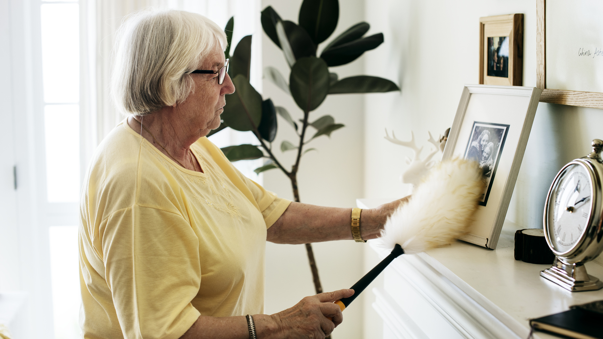 Senior cleaning her home