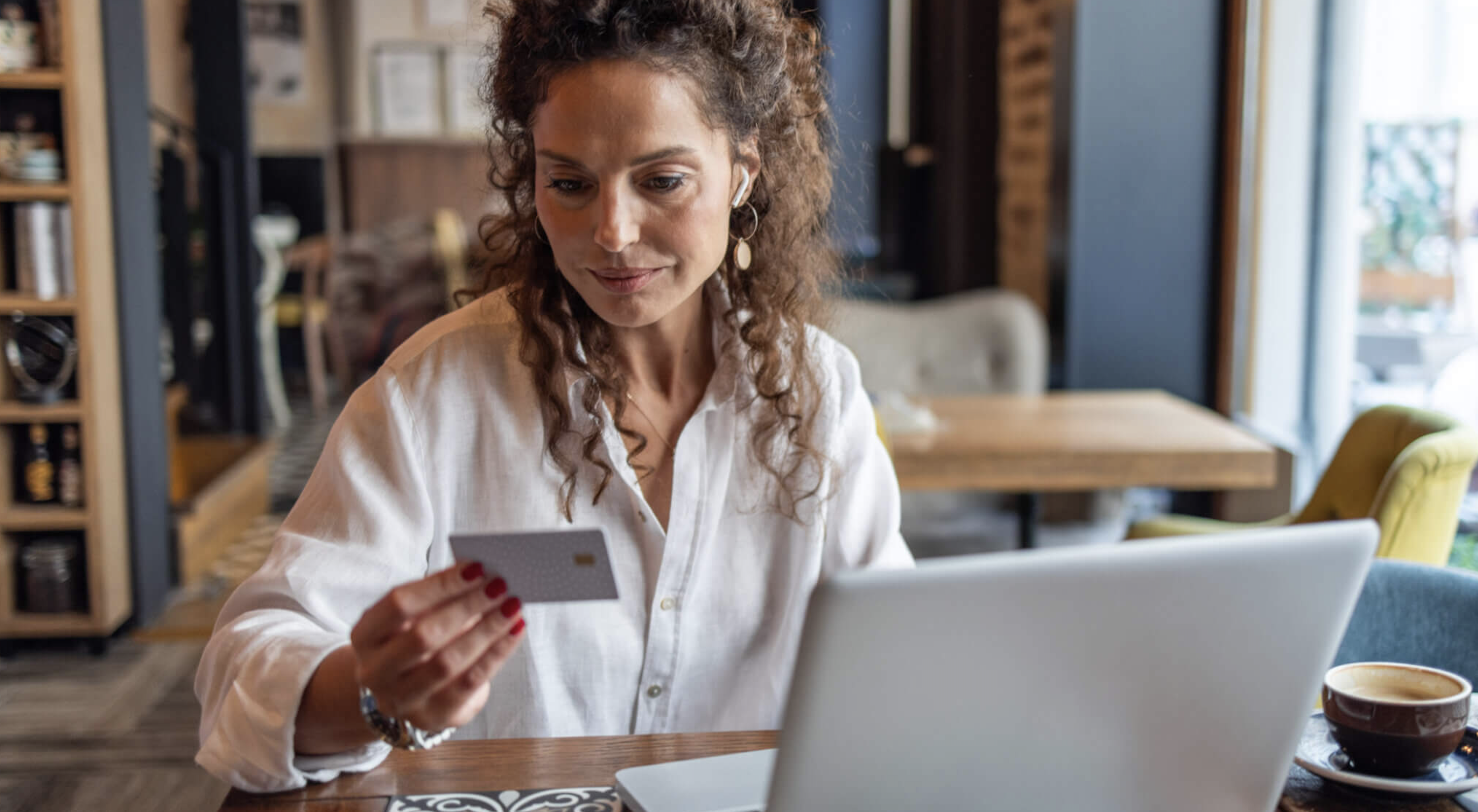 Woman in coffee shop with card