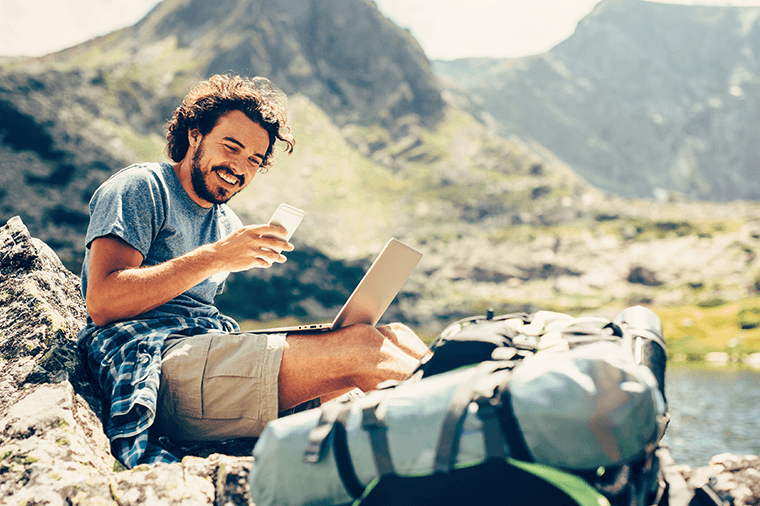 Man on mountains on phone