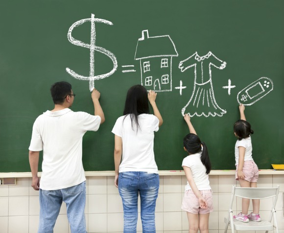 Family writing on chalkboard